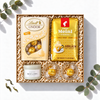 Geschenkbox Sanfter Morgenglanz mit Julius Meinl Jubiläum Kaffee, weißen Lindt Lindor Kugeln, Duftkerze und Espressogläsern, Ansicht von oben